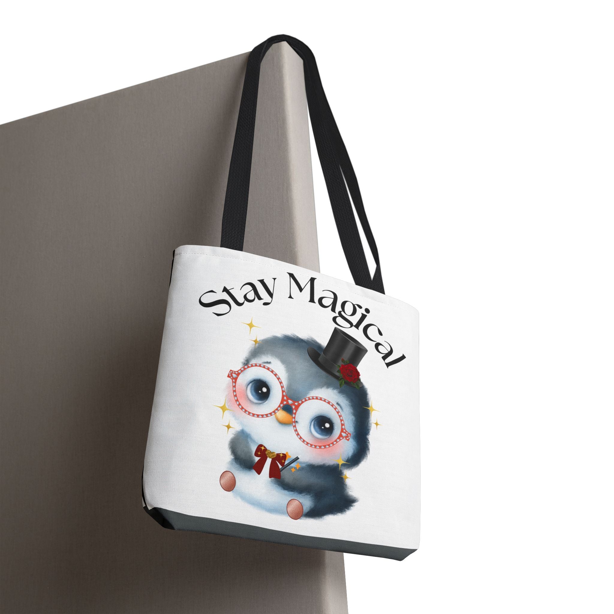 Tote bag with a penguin design and 'Stay Magical' text on a white background